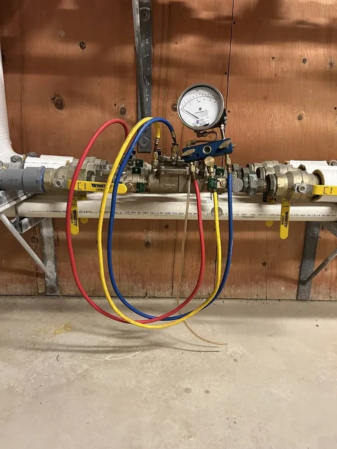 Backflow testing gauge connected to a prevention device during field testing